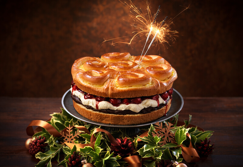 A photo of a St Pierre Brioche Tear and Share with a sparkler alight placed in the top