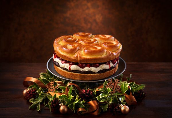 A Brioche Tear and Share sweet dessert on a cake stand filled with cherries and cream