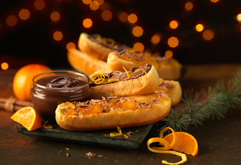 A photo of St Pierre Brioche Hot Dog Rolls sliced in half and spread with chocolate and orange marmalade