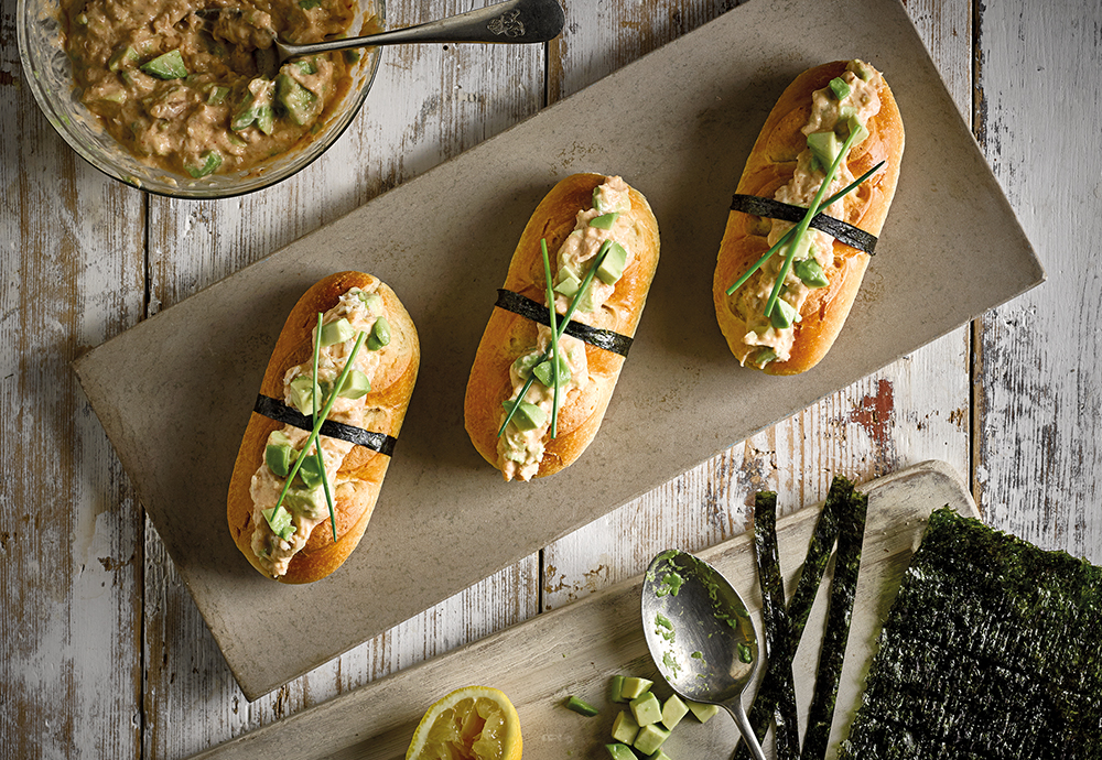 An overhead photo of three St Pierre Brioche Rolls filled with a crab and avocado mixture on a long serving plate