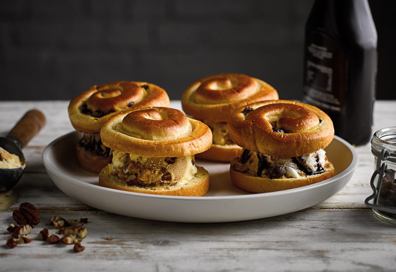 sp_web__0020_brioche_swirls_ice_cream_sandwich_cmyk_small Four St Pierre Brioche Swirls on a plate filled with vanilla ice cream and chocolate sauce on a plate