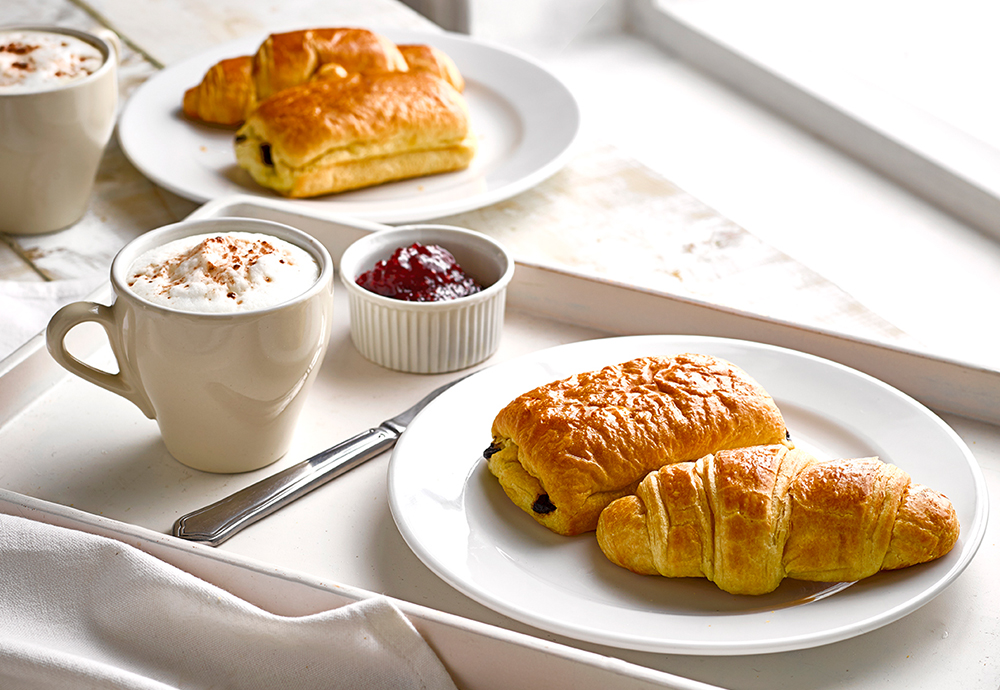 Our Classic French Breakfast recipe featuring a St Pierre Croissant and Pain au Chocolat on a table with a coffee and jam